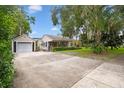 Tan house with a garage and driveway at 731 Midget Dr, Winter Park, FL 32789