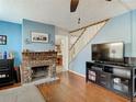 Living room with fireplace, hardwood floors, and built-in shelving at 610 S Laurel Ave, Sanford, FL 32771