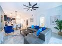 Open living space with gray sectional sofa and dining area at 951 Splash Shot Pl # 0, Davenport, FL 33896