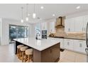 Modern kitchen with white cabinets, large island, and stainless steel appliances at 10951 Citron Oaks Dr, Orlando, FL 32836