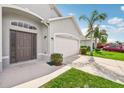 Dark brown front door with arched window and sidelights at 205 Marathon Ln, Sanford, FL 32771