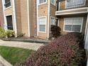 Exterior view of building and landscaping at 5587 Devonbriar Way # 105, Orlando, FL 32822