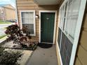 Front door entrance with landscaping at 5587 Devonbriar Way # 105, Orlando, FL 32822