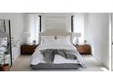 Bright bedroom with neutral tones, plush bedding, and wood nightstands at 33 S Graham Ave, Orlando, FL 32803