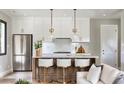 Modern kitchen with white cabinets, marble island, and gold accents at 33 S Graham Ave, Orlando, FL 32803