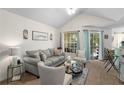 Living room with light-colored sofa and vaulted ceiling at 1069 S Hiawassee Rd # 1336, Orlando, FL 32835