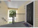 Apartment building entrance with black door and welcome mat at 1069 S Hiawassee Rd # 1336, Orlando, FL 32835