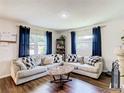 Bright living room with sectional sofa, coffee table, and hardwood floors at 240 People St, Maitland, FL 32751