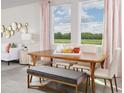 Dining area with wood table and bench seating, natural light at 1365 Current Pl, Haines City, FL 33844