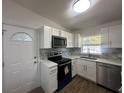 Modern kitchen with white shaker cabinets, quartz countertops and stainless steel appliances at 111 Lake Dot Dr, Sanford, FL 32773