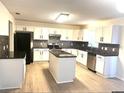 Modern kitchen with white cabinets, granite countertops, and stainless steel appliances at 366 Fairfield Dr, Sanford, FL 32771