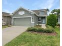 Front view of a two-car garage house with landscaping at 3402 Sagebrush St, Harmony, FL 34773