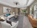 Open living room with a view into the kitchen and a neutral color scheme at 3402 Sagebrush St, Harmony, FL 34773