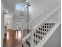 Elegant staircase with white railing and hardwood floors at 2286 Chatham Place Dr, Orlando, FL 32824