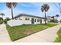 Side view of a newly renovated duplex, showcasing its landscaping and modern design at 701 N Grandview Ave, Daytona Beach, FL 32118