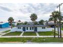 Front view of a newly renovated duplex with modern gray accents and a white exterior at 701 N Grandview Ave, Daytona Beach, FL 32118