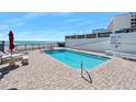 Refreshing community pool with ocean views and patio seating at 1404 N Atlantic Ave # 4, Daytona Beach, FL 32118