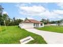 House exterior with white walls, brown roof, and a driveway at 11 Spruce Pass, Ocala, FL 34472