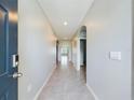 Bright and spacious foyer with neutral tile flooring and arched doorways at 1502 Jadewood Way, Kissimmee, FL 34744