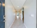 Neutral-toned entryway with tile floors and archways leading to other rooms at 1502 Jadewood Way, Kissimmee, FL 34744