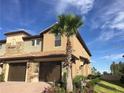 Tan two story townhome with a double garage at 8975 Azalea Sands Ln, Davenport, FL 33896