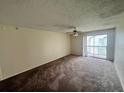 Living room with carpet and sliding door to balcony at 1932 Lake Atriums Cir # 70, Orlando, FL 32839