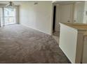 Spacious living room with carpet and balcony access at 1932 Lake Atriums Cir # 70, Orlando, FL 32839