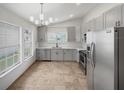 Modern kitchen featuring gray cabinets and stainless steel appliances at 112 Winterglen Dr, Sanford, FL 32771