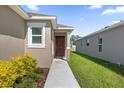 Side view of home with walkway and landscaping at 607 Alder Ln, Auburndale, FL 33823