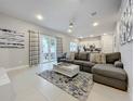 Spacious living room with sectional sofa and large sliding glass doors at 7740 Sandy Ridge Dr # 100, Reunion, FL 34747