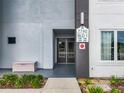 Building entrance with double doors and a stone bench at 7740 Sandy Ridge Dr # 100, Reunion, FL 34747