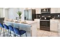Modern kitchen with stainless steel appliances and an island at 3161 Paradox Cir # 202, Kissimmee, FL 34746