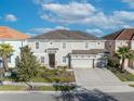 An aerial view of the home and surrounding properties, including the driveway and lush landscaping at 7009 Oakwood St, Davenport, FL 33837