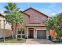 Two-story house with gray garage and terracotta roof at 5424 Solterra Cir # 1, Davenport, FL 33837