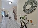 Bright entryway with glass-top table and staircase at 5424 Solterra Cir # 1, Davenport, FL 33837