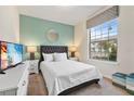 Spacious bedroom with large window and modern furnishings at 2428 Dubai St, Kissimmee, FL 34747