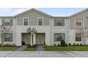 Modern two-story townhome with gray siding and teal shutters at 2428 Dubai St, Kissimmee, FL 34747