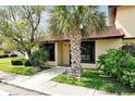 Front view of condo showing walkway, landscaping, and building number at 406 Hunter Cir, Kissimmee, FL 34758