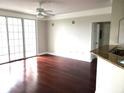 Bright living room with hardwood floors and sliding glass doors at 3480 Soho St # 201, Orlando, FL 32835