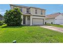 Two-story house with gray siding, double car garage, and manicured lawn at 2548 Lyndscape St, Orlando, FL 32833