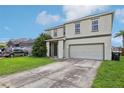 Two-story house with gray siding, double car garage, and manicured lawn at 2548 Lyndscape St, Orlando, FL 32833