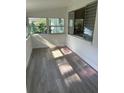 Bright sunroom with wood-look flooring and multiple windows at 830 Wooden Blvd, Orlando, FL 32805