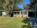 Ranch style home with gray siding and stone facade at 830 Wooden Blvd, Orlando, FL 32805