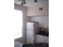 Efficient kitchen with white cabinets, microwave, and refrigerator at 6320 Raleigh St # 604, Orlando, FL 32835