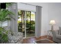 Living room with comfy seating, sliding doors, and wood floors at 703 Lucaya Loop # 1103, Davenport, FL 33897