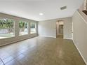 Spacious living room with tiled floors and large windows at 15106 Ovation Dr, Winter Garden, FL 34787