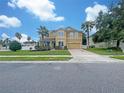 Two-story house, yellow facade, landscaping, and a driveway at 15106 Ovation Dr, Winter Garden, FL 34787