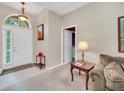 Bright and airy entryway with tiled flooring and a view into the living room at 3853 Fallscrest Cir, Clermont, FL 34711