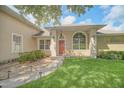 Inviting entryway with a red door and stone pathway at 11062 Crescent Bay Blvd, Clermont, FL 34711