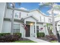 Two-story home with neutral siding, brown door, and landscaping at 3211 Gold Ln, Kissimmee, FL 34747